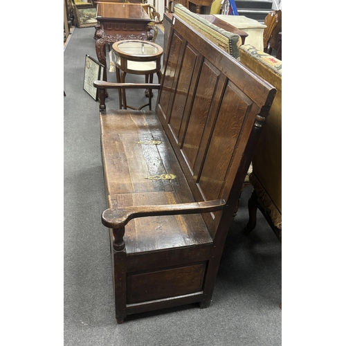 1166 - An 18th century panelled oak box seat settle, width 153cm, depth 51cm, height 108cm