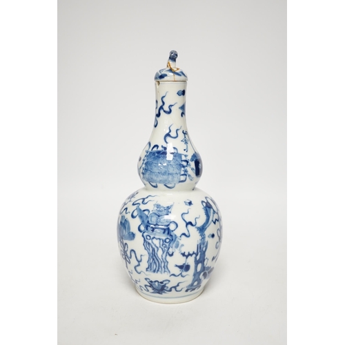 1251 - A late 19th century Chinese blue and white double gourd vase and cover 26cm high