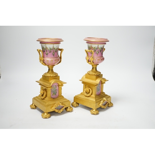 1252 - A pair of late 19th century French ormolu and pink floral porcelain urns, 20.5cm high