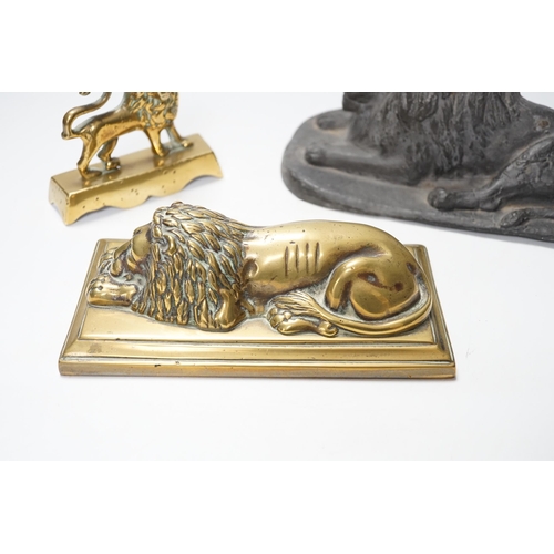 1266 - A 19th century brass recumbent lion, a similar cast iron lion and a smaller lion, largest 22cm wide... 