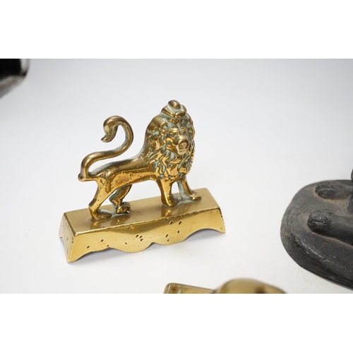 1266 - A 19th century brass recumbent lion, a similar cast iron lion and a smaller lion, largest 22cm wide... 