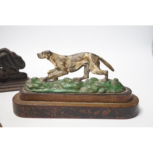 1285 - Two cast iron lion door stops and a painted dog door stop, 21cm wide