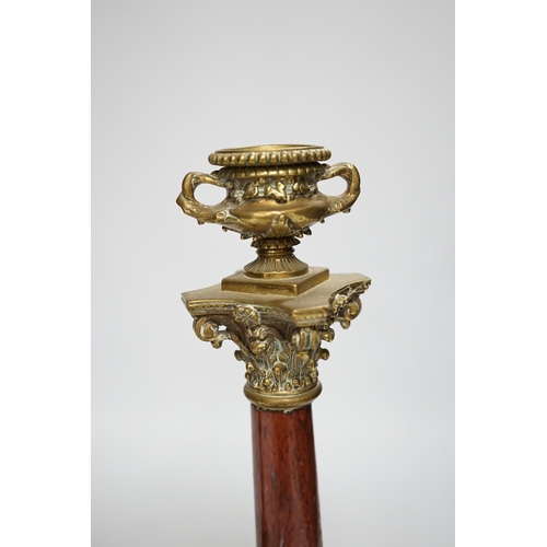 1303 - A pair of 19th century brass mounted rouge marble candlesticks, 29cm (a.f.)