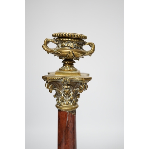 1303 - A pair of 19th century brass mounted rouge marble candlesticks, 29cm (a.f.)