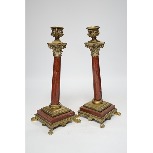 1303 - A pair of 19th century brass mounted rouge marble candlesticks, 29cm (a.f.)