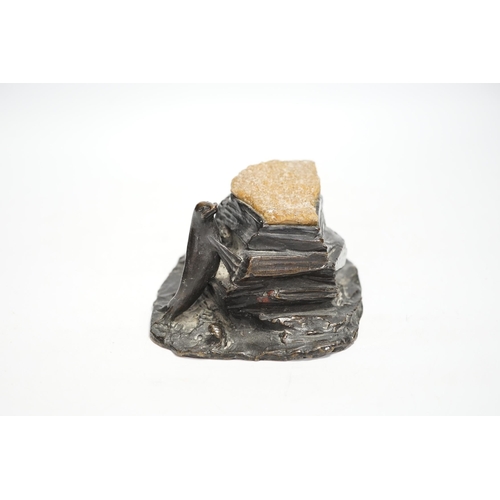 1333 - A bronze desk weight, a seal on rock, quartz mounted, 15cm wide