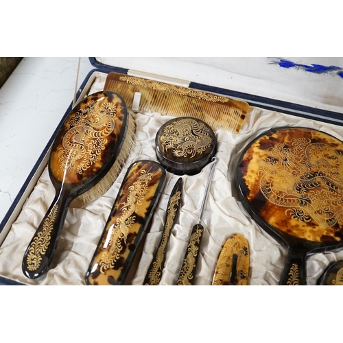 1338 - A cased Japanese tortoiseshell dragon decorated dressing table set, c.1940 (with original packing ca... 