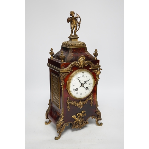 1357 - A late 19th century French tortoiseshell veneered mantel clock with cupid top, striking on a coiled ... 