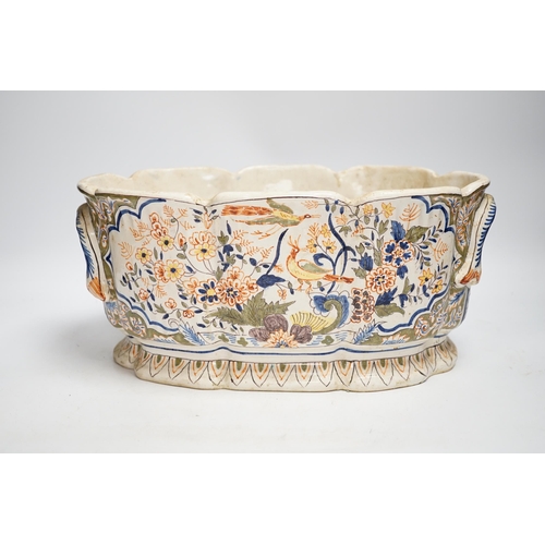 1359 - A Two French faience pottery planters, one with armorial crest and another, longer 34cm (2)