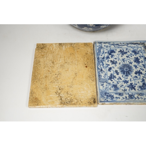 1363 - A 19th century Chinese blue and white prunus jar and cover, together with two similar tiles, jar 21c... 