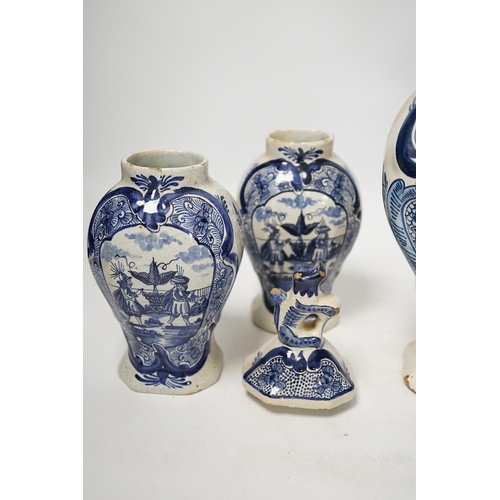 1379 - An 18th century Delft blue and white vase and a pair of later Delft vases and covers, tallest 23.5cm... 