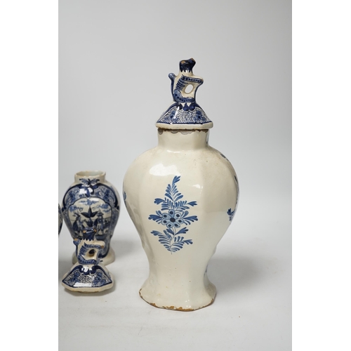 1379 - An 18th century Delft blue and white vase and a pair of later Delft vases and covers, tallest 23.5cm... 