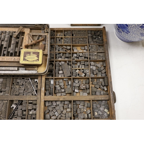 1428 - Three trays of metal printing type: chases, quoins and spacing bars