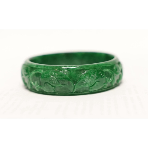 1451 - A Chinese carved jadeite bangle, 7.5cm in diameter