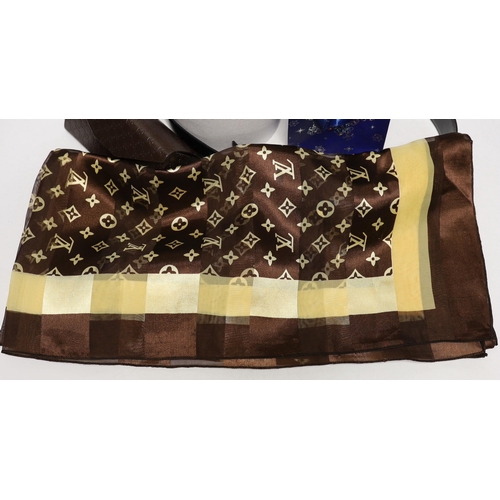 1456 - A Louis Vuitton brown and gold Monogram scarf, a thin Gucci Mormont belt, with brushed gold tone GG ... 