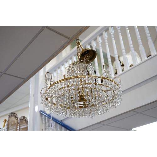 1463 - A three tier brass and glass chandelier, 44cm diameter