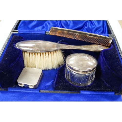 1917 - A George V engine turned silver pill box, 34mm and a cased silver mounted three piece toilet set.... 