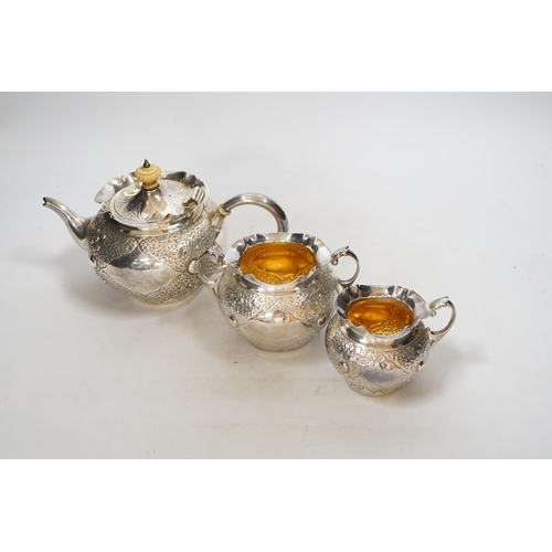 1930 - A Victorian embossed silver three piece bachelors tea set, Charles Edwards, London, 1880, gross weig... 