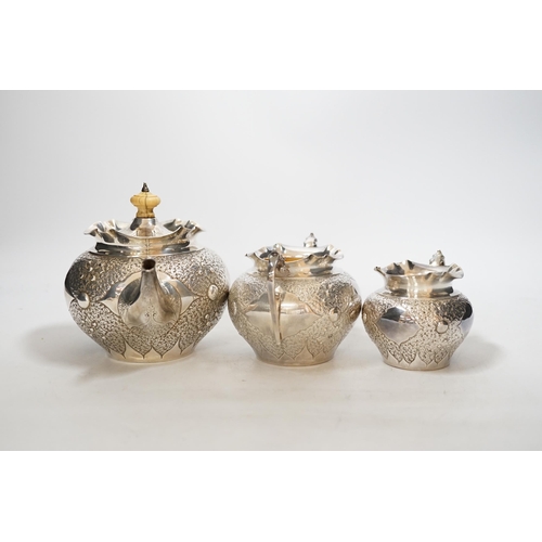 1930 - A Victorian embossed silver three piece bachelors tea set, Charles Edwards, London, 1880, gross weig... 