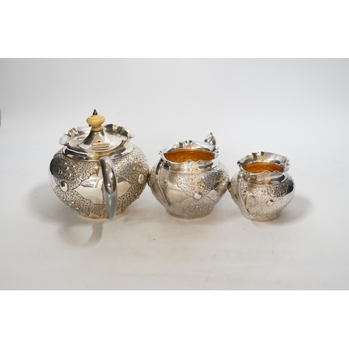 1930 - A Victorian embossed silver three piece bachelors tea set, Charles Edwards, London, 1880, gross weig... 