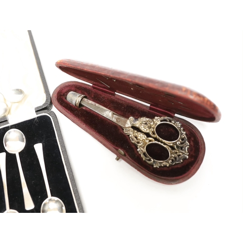 1934 - A cased pair of late Victorian repousse silver handled scissors and later silver thimble, a silver m... 