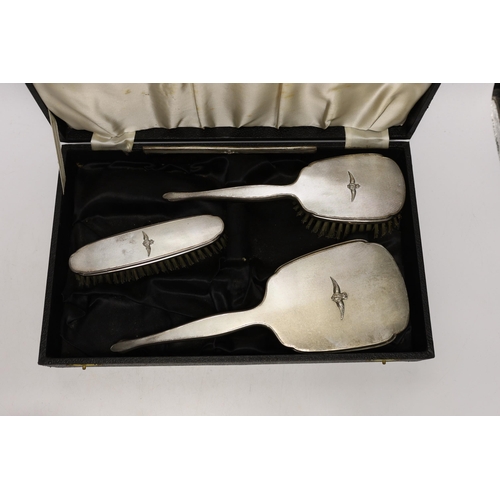 1938 - An Elizabeth II cased silver mounted three piece mirror and brush set, with RAF wings applique, twel... 