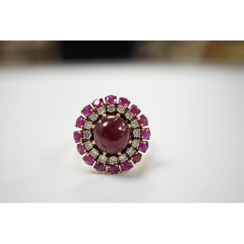 1975 - A yellow metal, ruby and diamond set circular cluster dress ring, with central cabochon ruby, size M... 