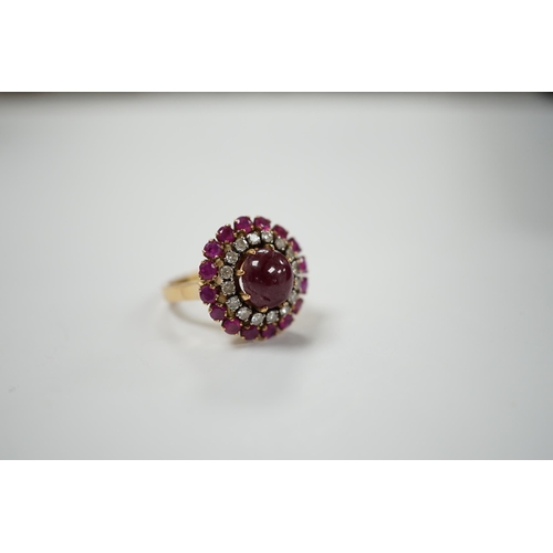 1975 - A yellow metal, ruby and diamond set circular cluster dress ring, with central cabochon ruby, size M... 