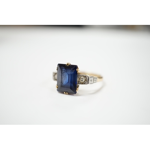 1976 - An 18ct, plat and single stone emerald cut synthetic? sapphire set dress ring with diamond set shoul... 