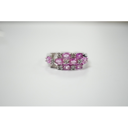 1982 - A modern 14k white metal, pink sapphire and diamond cluster set half hoop ring (two sapphires loose)... 