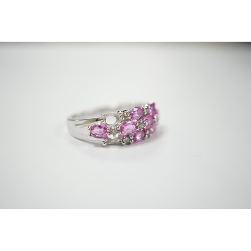 1982 - A modern 14k white metal, pink sapphire and diamond cluster set half hoop ring (two sapphires loose)... 