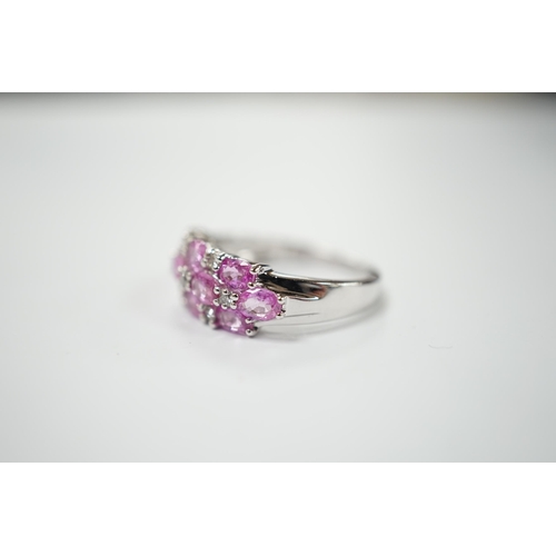 1982 - A modern 14k white metal, pink sapphire and diamond cluster set half hoop ring (two sapphires loose)... 