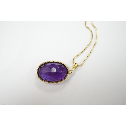 1985 - A yellow metal mounted single stone oval cut amethyst set pendant, 35mm, on a yellow metal chain, 48... 