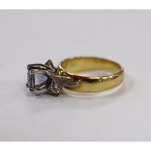 1991 - An 18ct and single stone oval cut sapphire set dress ring, with diamond set shoulders, size I, gross... 