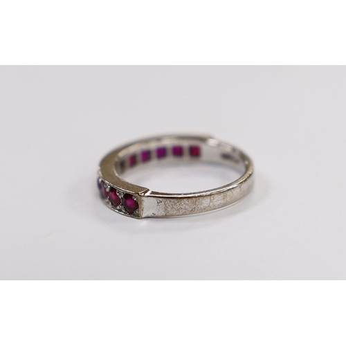 1992 - An 18ct white gold and eleven stone ruby set half eternity ring, size L, gross weight 3.8 grams.... 