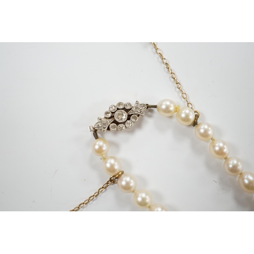 1996 - A single strand graduated cultured pearl necklace with millegrain set diamond cluster and yellow met... 