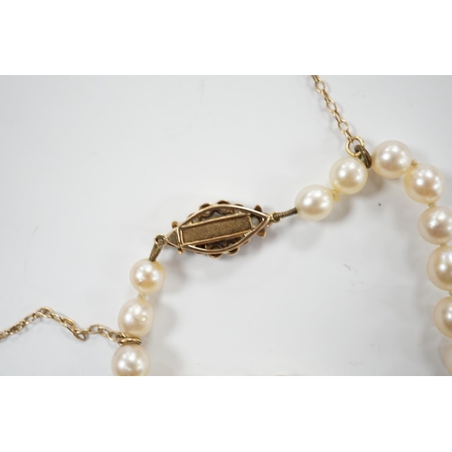 1996 - A single strand graduated cultured pearl necklace with millegrain set diamond cluster and yellow met... 