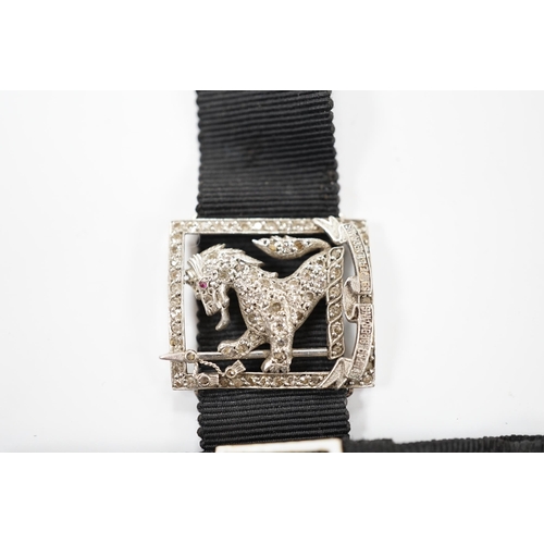 1999 - A black sash bracelet with diamond and enamel set Royal Fusiliers buckle, together with a similar sa... 