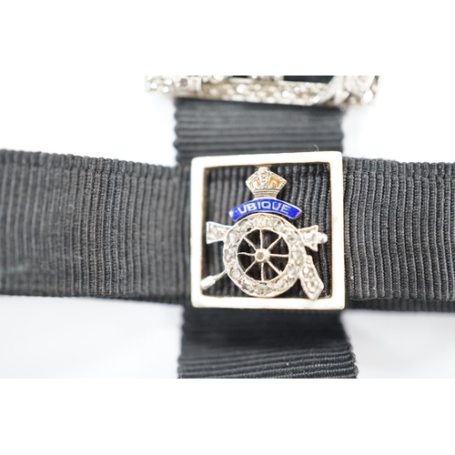 1999 - A black sash bracelet with diamond and enamel set Royal Fusiliers buckle, together with a similar sa... 