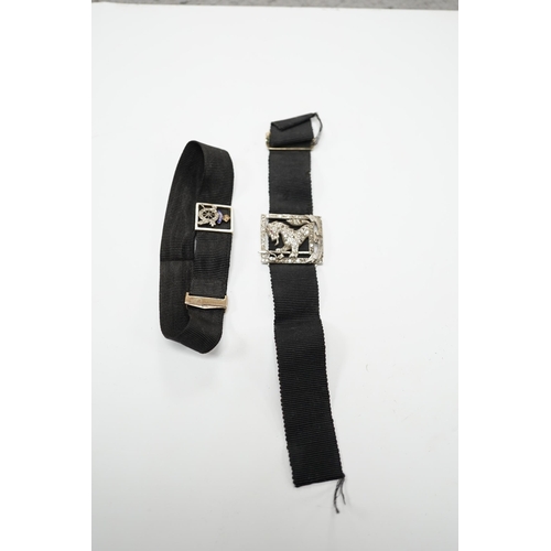 1999 - A black sash bracelet with diamond and enamel set Royal Fusiliers buckle, together with a similar sa... 