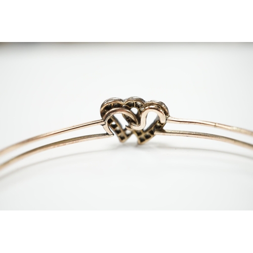 2009 - A late Victorian yellow metal and rose cut diamond set twin hearts bangle, gross weight 6.8 grams.... 