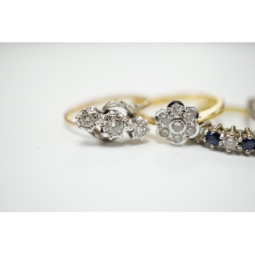 2035 - Four assorted 18ct and diamond set rings, including solitaire, flower head cluster, three stone cros... 