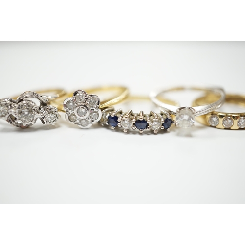 2035 - Four assorted 18ct and diamond set rings, including solitaire, flower head cluster, three stone cros... 