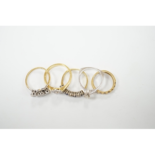 2035 - Four assorted 18ct and diamond set rings, including solitaire, flower head cluster, three stone cros... 