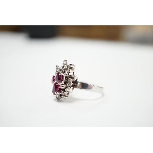 2053 - A recent 18k white metal, ruby and diamond cluster set modernist dress ring, size N/O, gross weight ... 