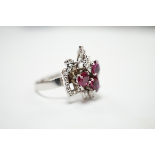 2053 - A recent 18k white metal, ruby and diamond cluster set modernist dress ring, size N/O, gross weight ... 