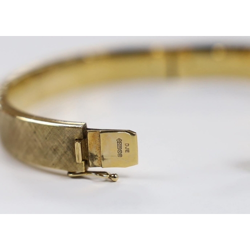 2059 - A brushed 9ct gold hinged bangle, interior diameter 63mm, 28.5 grams.