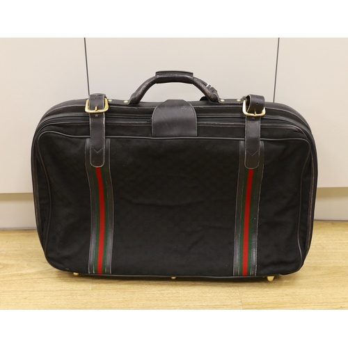 1462 - A black fabric and leather trimmed Gucci suitcase Condition worn