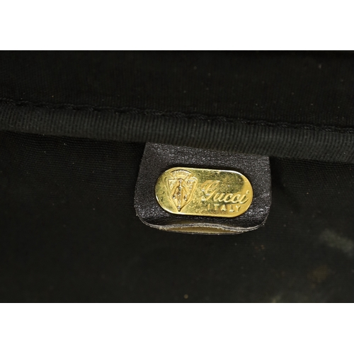 1462 - A black fabric and leather trimmed Gucci suitcase Condition worn