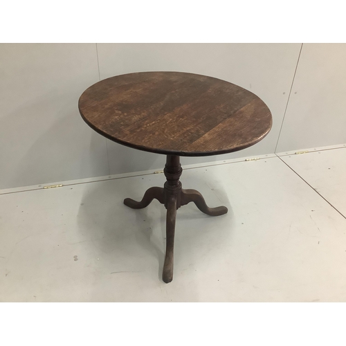 101 - A George III circular oak tilt top tripod tea table, diameter 75cm, height 70cm